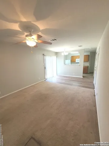 a view of empty room with window and fireplace