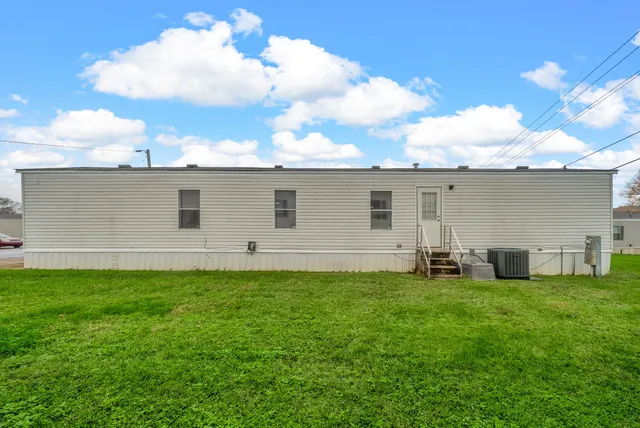 a backyard of a house with table and chairs