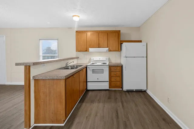 a kitchen with a stove a sink and a refrigerator