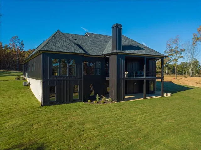 a view of an empty room with fire place and windows