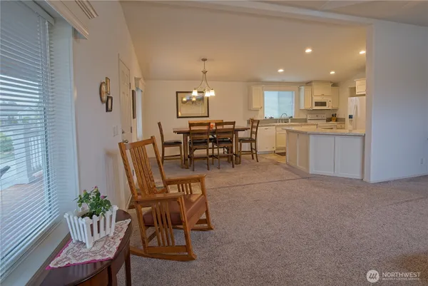 a view of a dining room with furniture and chandelier