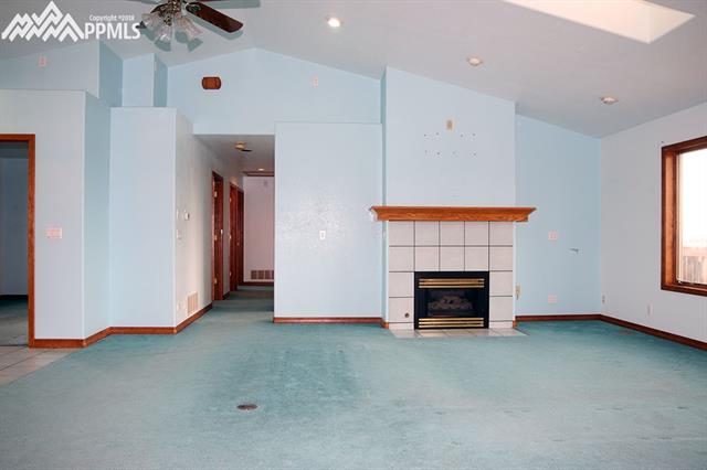 24445 Speer Road Calhan, CO 80808 - Photo 2 of 12 gas fireplace and hall to bedrooms