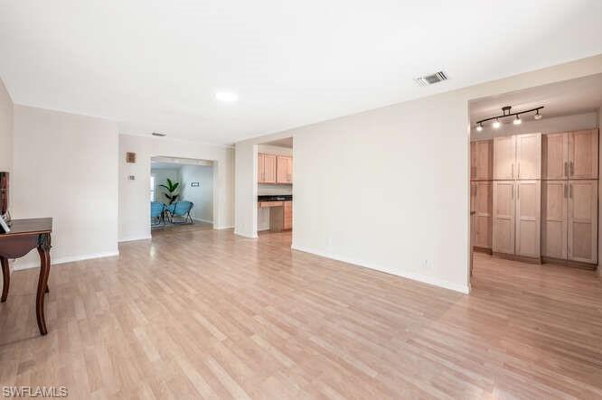 778 Broad Court South Naples, FL 34102 - Photo 13 of 36 a view of livingroom with hardwood floor and a ceiling fan