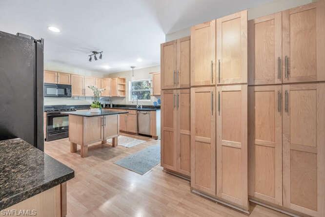 778 Broad Court South Naples, FL 34102 - Photo 14 of 36 a kitchen with stainless steel appliances granite countertop a refrigerator and a sink