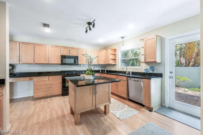 778 Broad Court South Naples, FL 34102 - Photo 15 of 36 a kitchen with stainless steel appliances granite countertop a stove a sink dishwasher and a refrigerator