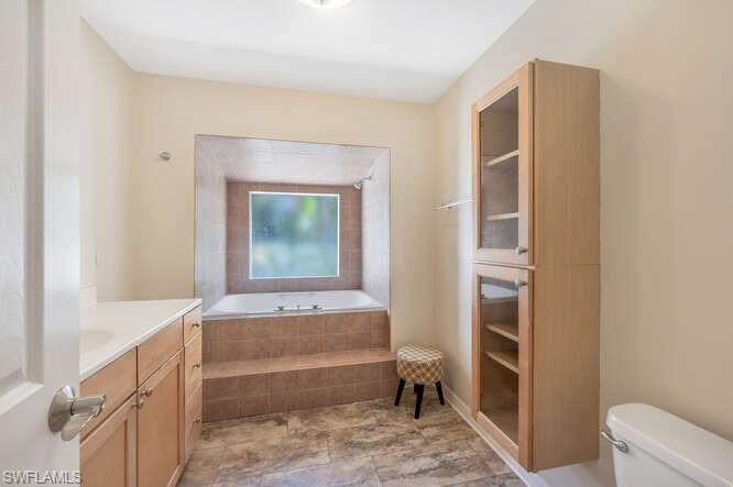 778 Broad Court South Naples, FL 34102 - Photo 18 of 36 a bathroom with a tub and a sink