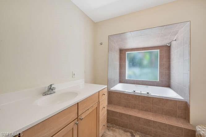 778 Broad Court South Naples, FL 34102 - Photo 19 of 36 a bathroom with a sink and a mirror