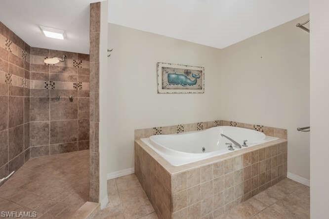 778 Broad Court South Naples, FL 34102 - Photo 28 of 36 a bathroom with a white bath tub and a shower