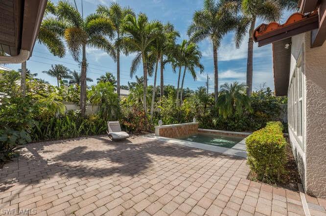 778 Broad Court South Naples, FL 34102 - Photo 30 of 36 a view of a backyard with palm trees