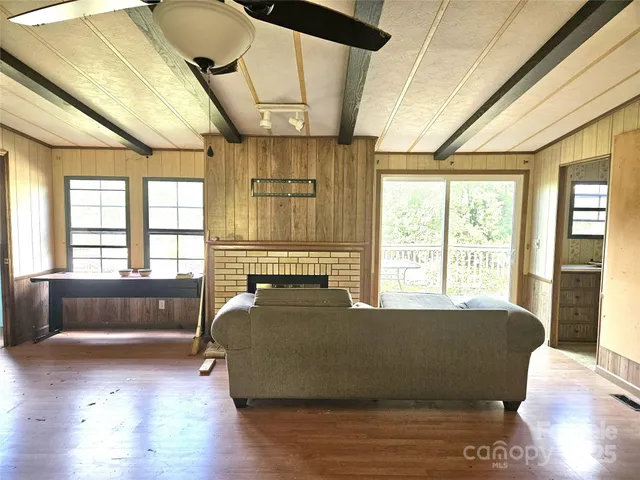 a living room with a bed furniture and next to a window