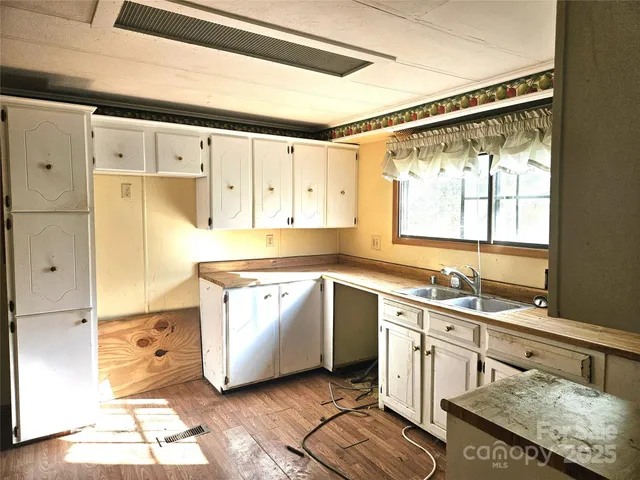 a kitchen with a sink cabinets and window