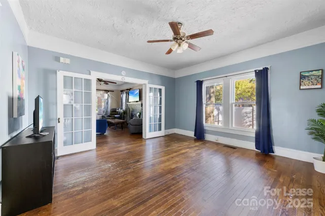 a view of a livingroom with hardwood floor and a ceiling fan