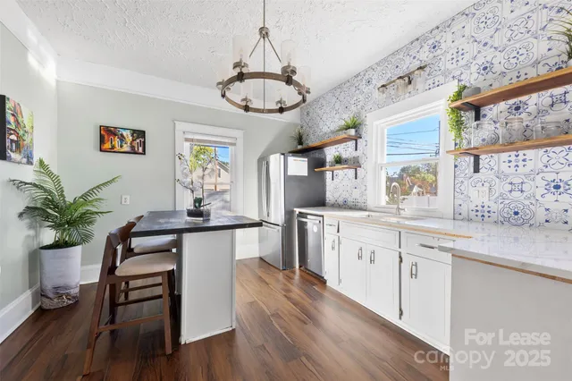 a kitchen with a table and chairs in it
