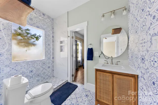 a bathroom with a toilet sink and mirror
