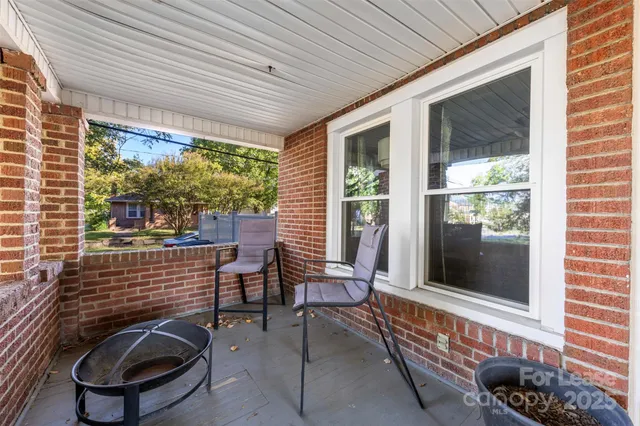 a view of porch with a chair and a potted plant