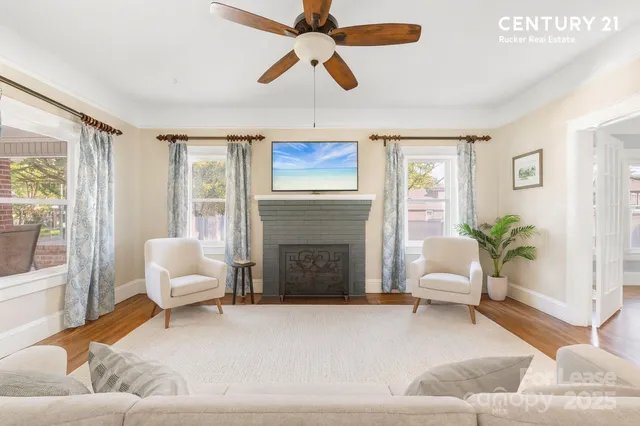 a living room with furniture and a fireplace