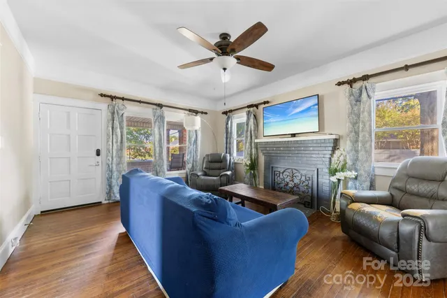 a living room with furniture and a fireplace