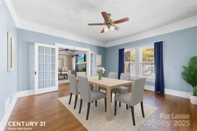 a view of a dining room with furniture window and wooden floor