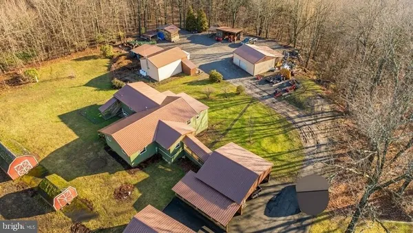 an aerial view of a house with table and chairs