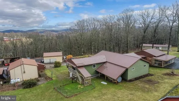 a view of a house with pool and a yard
