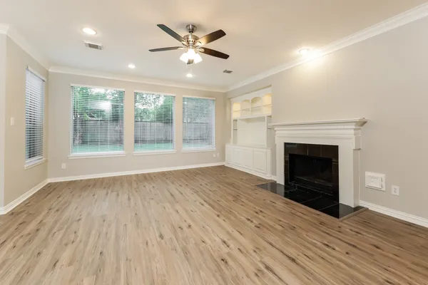 a view of a room with wooden floor cabinets and entryway