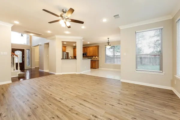 a view of a kitchen with microwave and windows