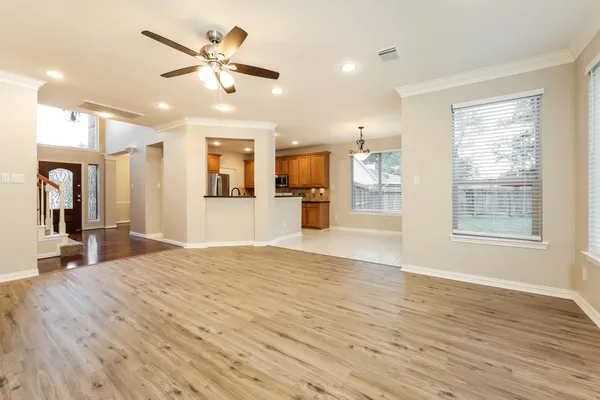 a view of a kitchen with microwave and windows