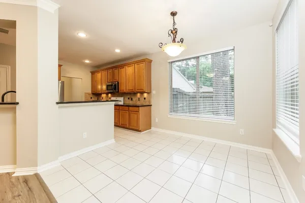 a large kitchen with stainless steel appliances a sink and cabinets