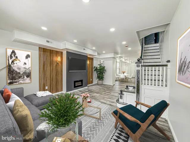 a living room with furniture a couch and a flat screen tv