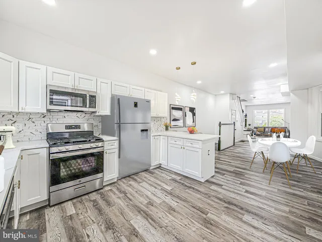 a kitchen with stove cabinets and refrigerator
