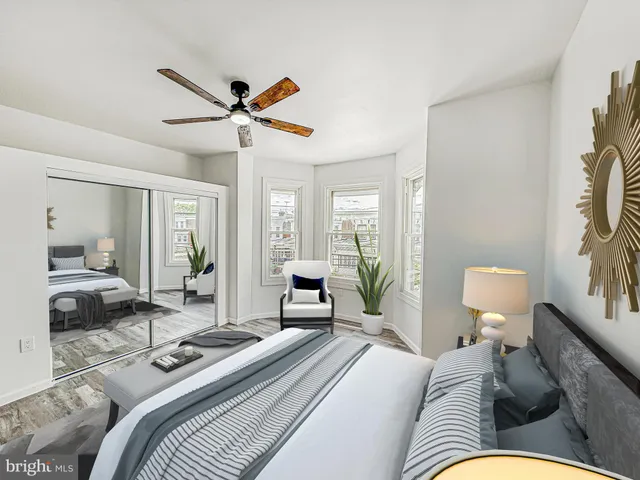 a bedroom with furniture and a large window