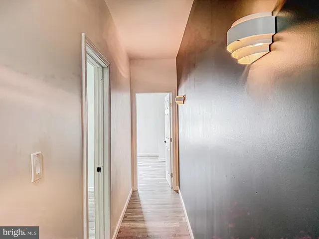 a view of a room with wooden floor