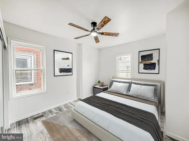 a bedroom with a large bed and a window