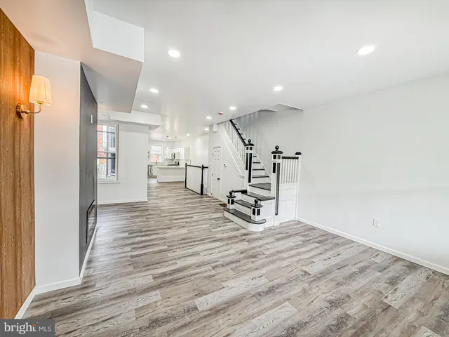 a view of a livingroom with chairs and wooden floor