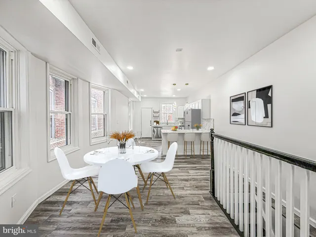 a dining room with furniture and a window
