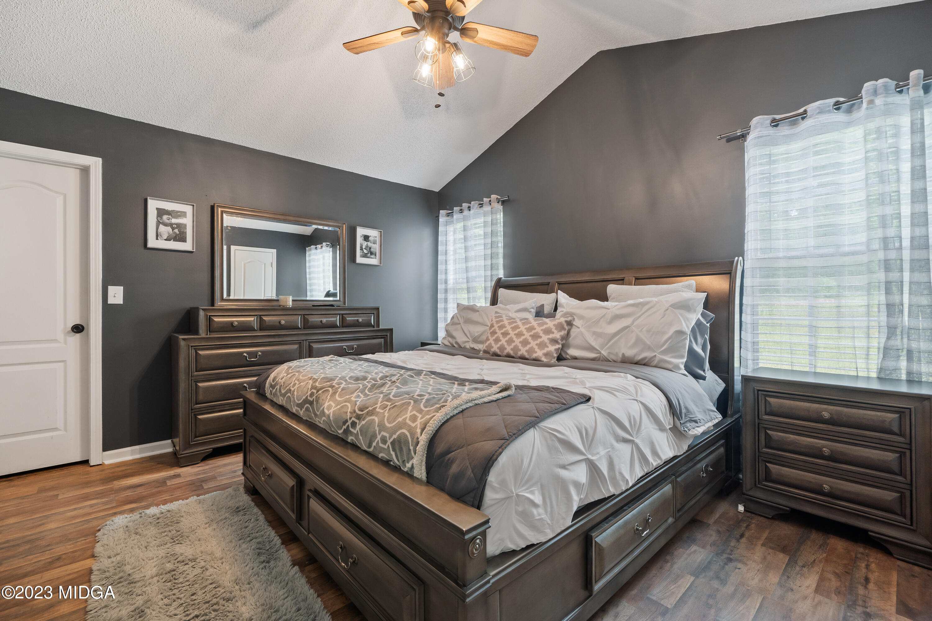 259 Autumn Ridge Court Gray, GA 31032 - Photo 11 of 18 a bedroom with a bed and a chandelier
