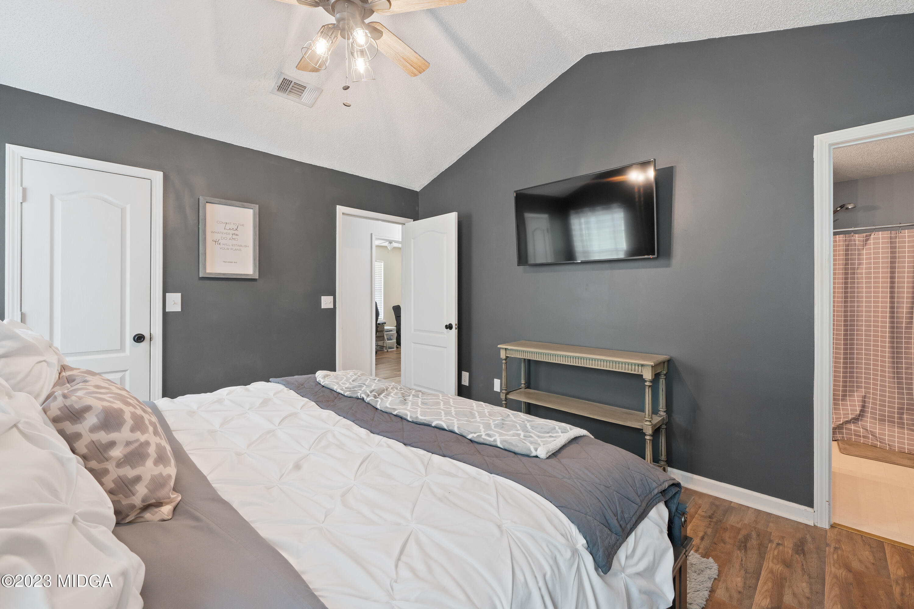 259 Autumn Ridge Court Gray, GA 31032 - Photo 12 of 18 a bedroom with a bed and a chandelier