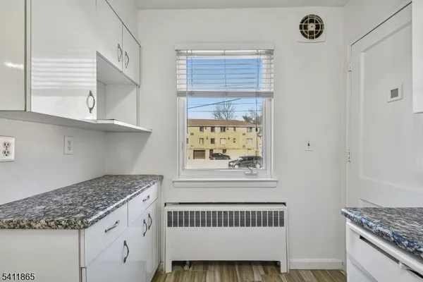 a kitchen with granite countertop cabinets appliances and a window