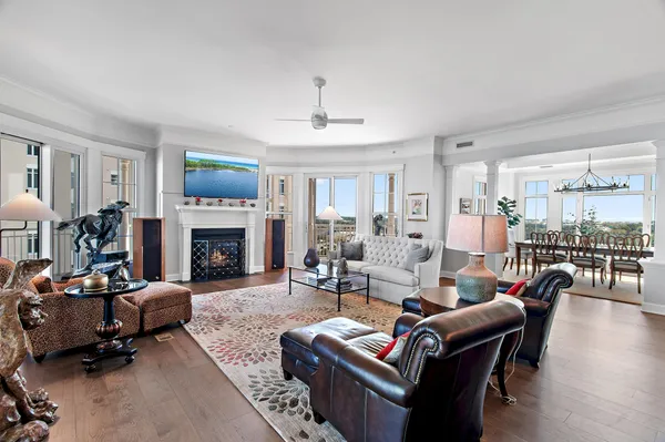 a dining room with furniture a chandelier and wooden floor