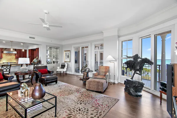 a living room with furniture a fireplace and a floor to ceiling window