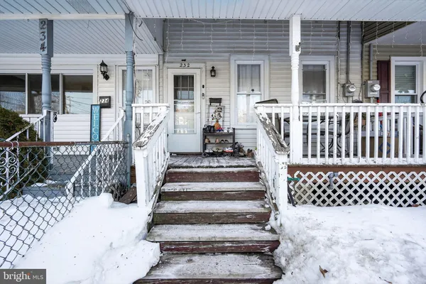 a view of a house with wooden fence