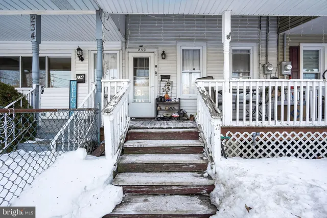 a view of a house with wooden fence