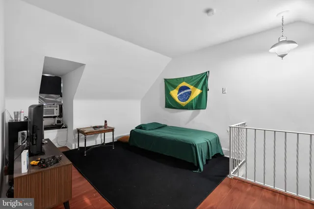 a bedroom with bed and a large window