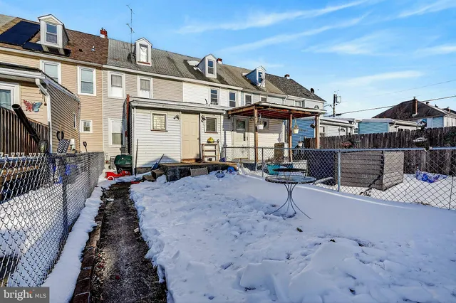 a view of a house with wooden fence