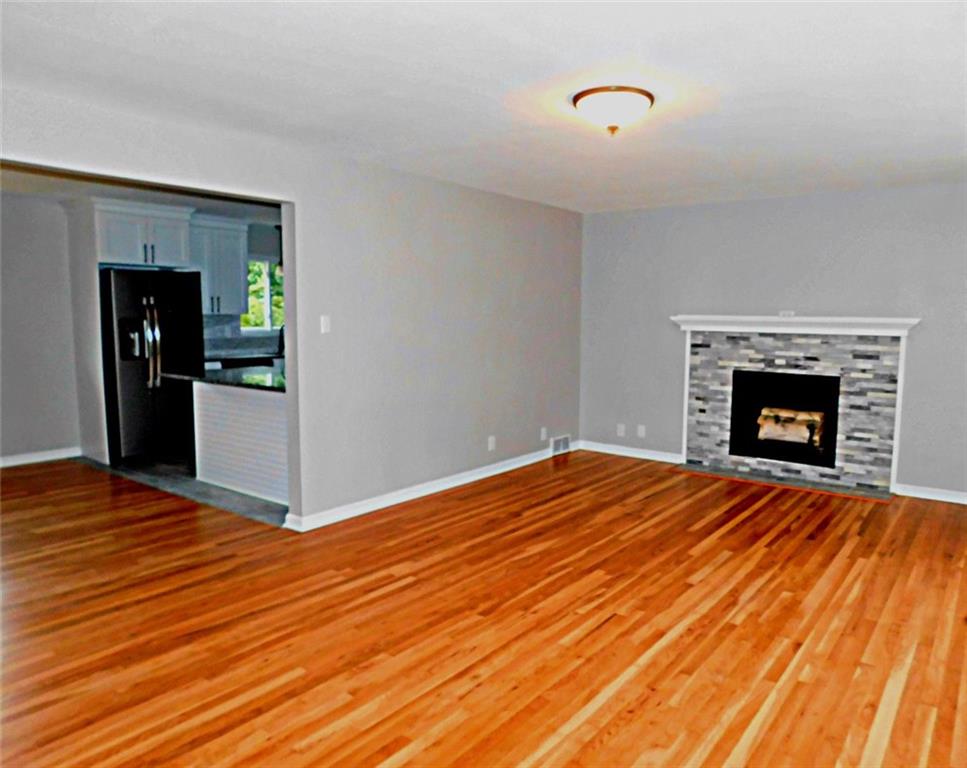 26 Porters Hollow Road Coraopolis, PA 15108 - Photo 6 of 25 Large living room with hardwood floors and gas fireplace