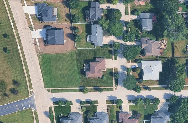 an aerial view of a house with a garden and mountain view