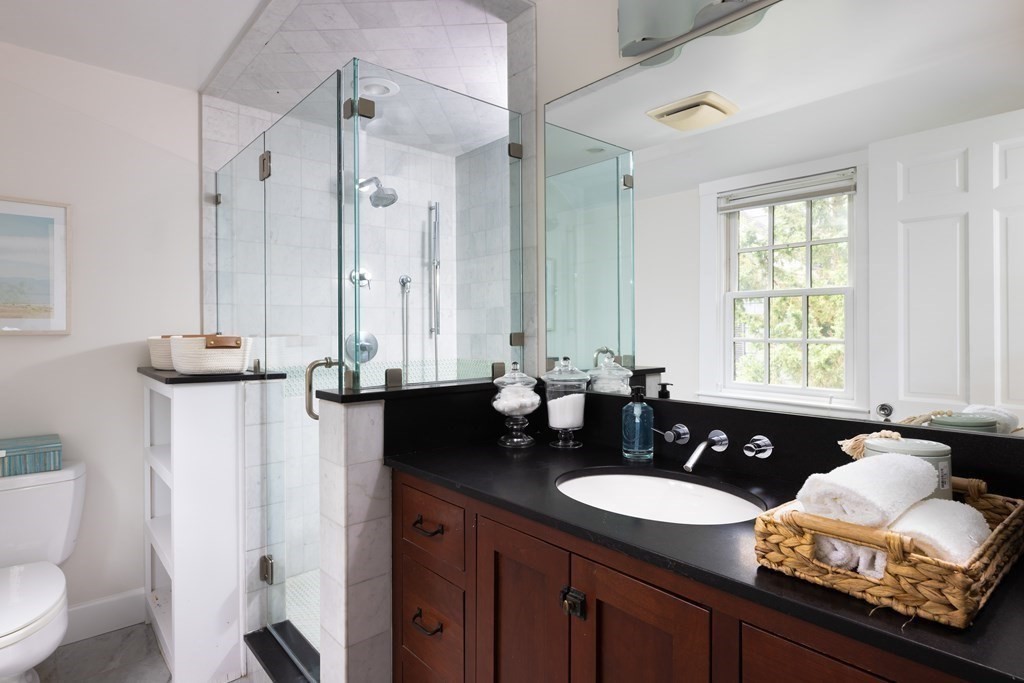 43 Somerset Road Brookline, MA 02445 - Photo 15 of 18 a bathroom with a granite countertop sink and a mirror