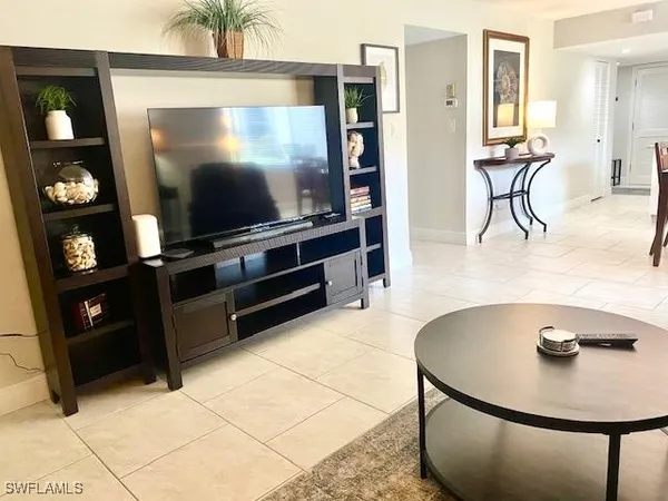 a living room with furniture and a lamp