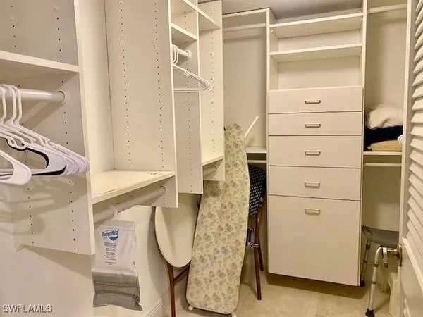 a bedroom with a bed and a lamp