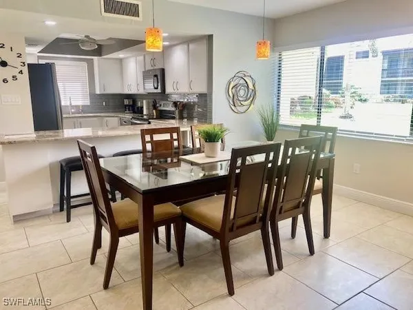 a view of a dining room with furniture and a large window